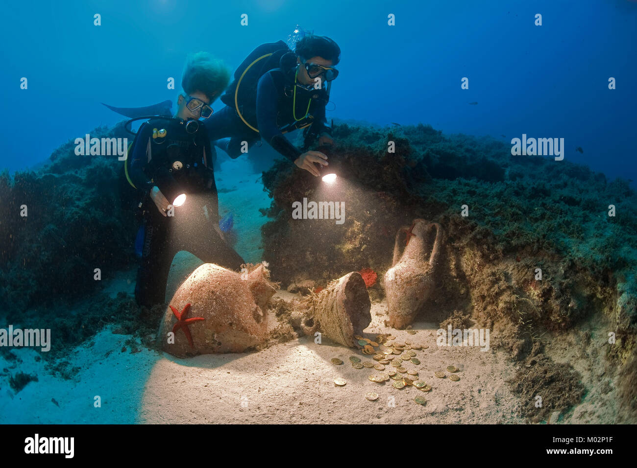 Scuba diver discovers gold coins in old amphoras of 2nd century B.C., Lykia, Mediterranean sea, Turkey Stock Photo