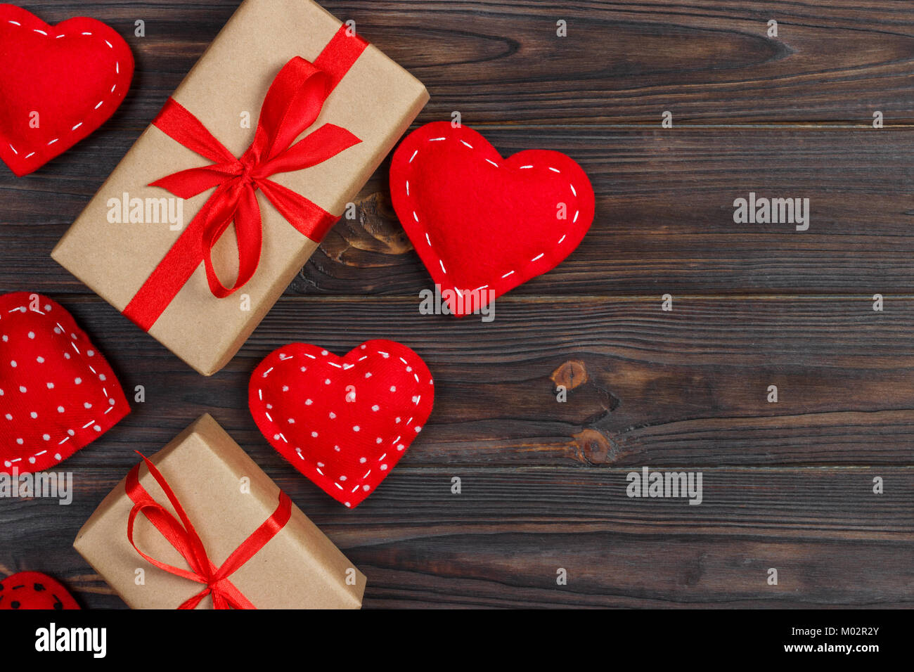 Heart and gift box with red ribbon on wooden background Stock Photo - Alamy