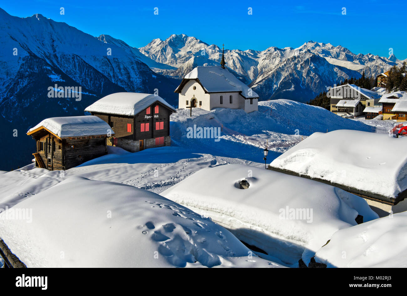 Switzerland: the village of Bettmeralp covered in snow. Houses and chapel 'Maria zum Schnee', St Mary of the Snow Stock Photo