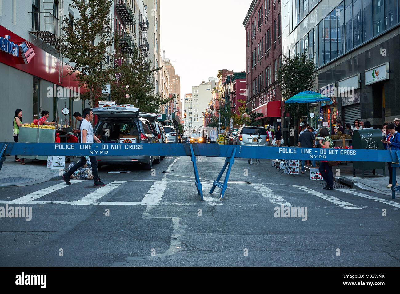 NEW YORK CITY - SEPTEMBER 24, 2016: Police line at the Hester street and Bowery Street cross, with people crossing the street Stock Photo