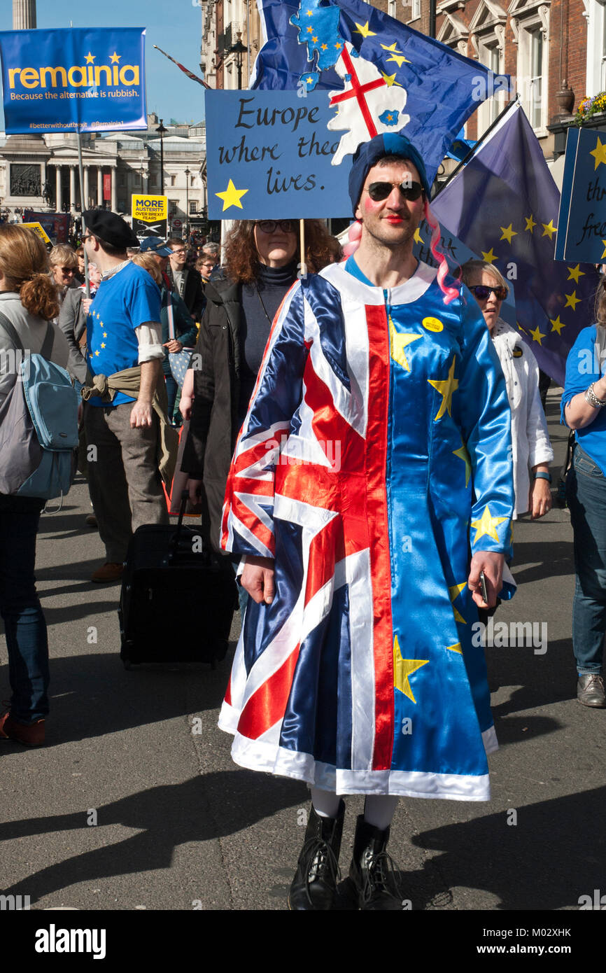 Anti Brexit demonstration. Young man wearing colourful dress made from Union Jack and EU flag, wearing lipstick. Humourus/ colourful. Stock Photo