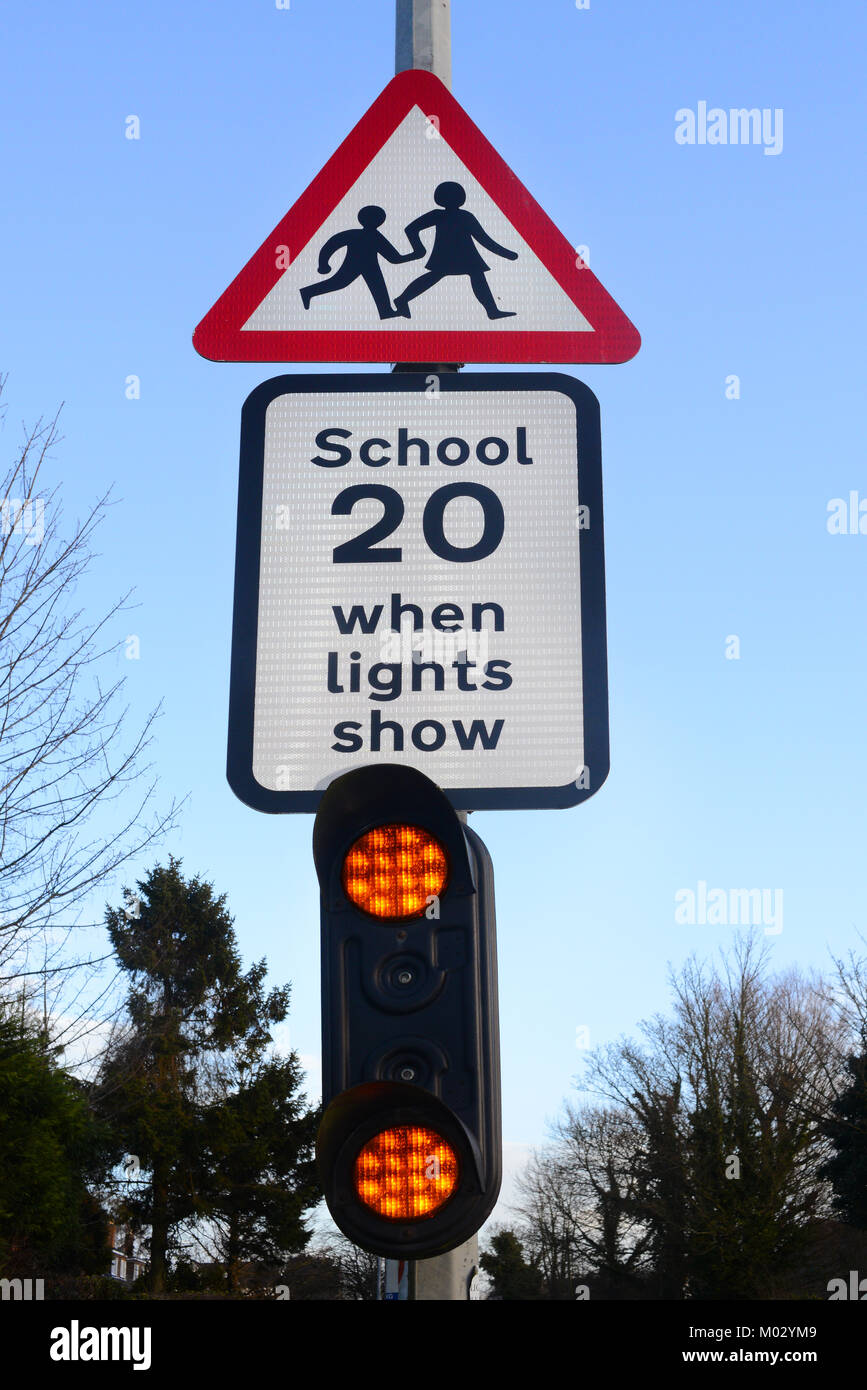warning lights and sign for drivers of school ahead united kingdom Stock Photo