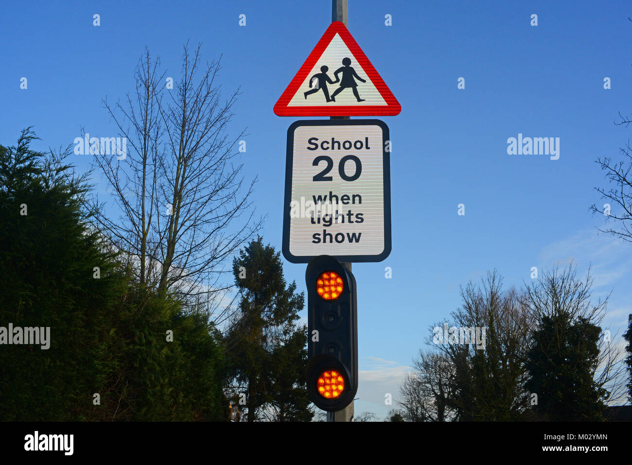 warning lights and sign for drivers of school ahead united kingdom Stock Photo