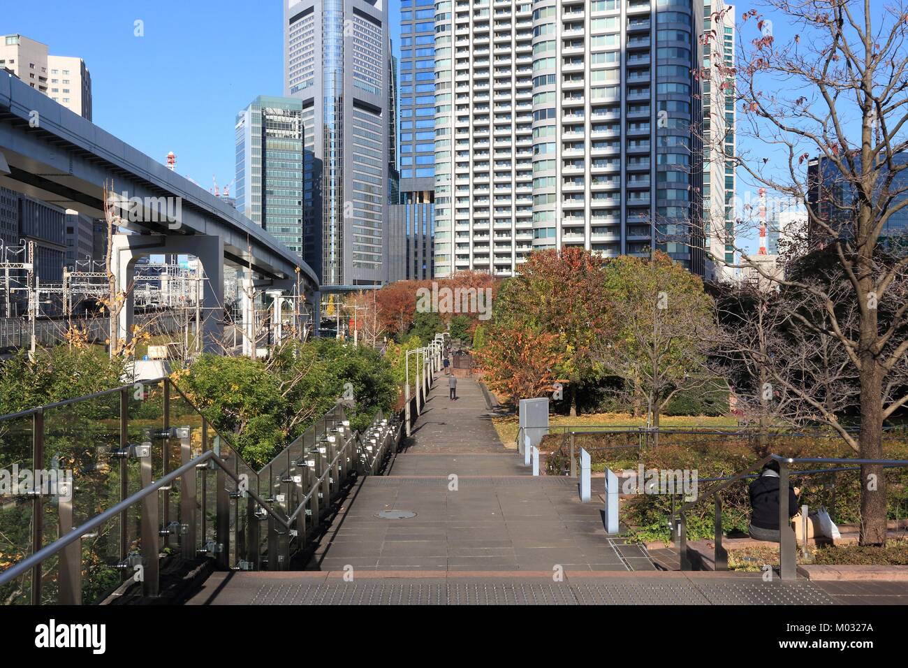 Shiodome, Tokyo - modern city architecture with elevated expressways. Autumn park. Stock Photo