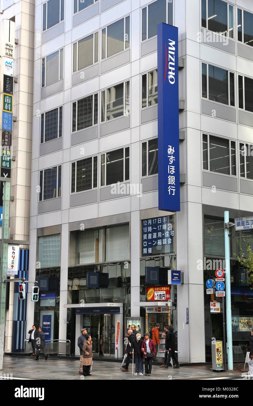 TOKYO, JAPAN - DECEMBER 1, 2016: People visit Mizuho Bank branch in Tokyo, Japan. Mizuho has 505 branches in Japan. Stock Photo