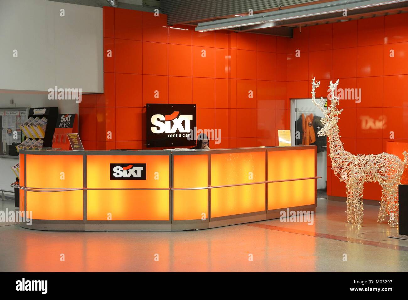 HAHN, GERMANY - DECEMBER 7, 2016: Sixt car rental employee waits for customers at Frankfurt Hahn Airport in Germany. Sixt has some 4,000 locations in  Stock Photo