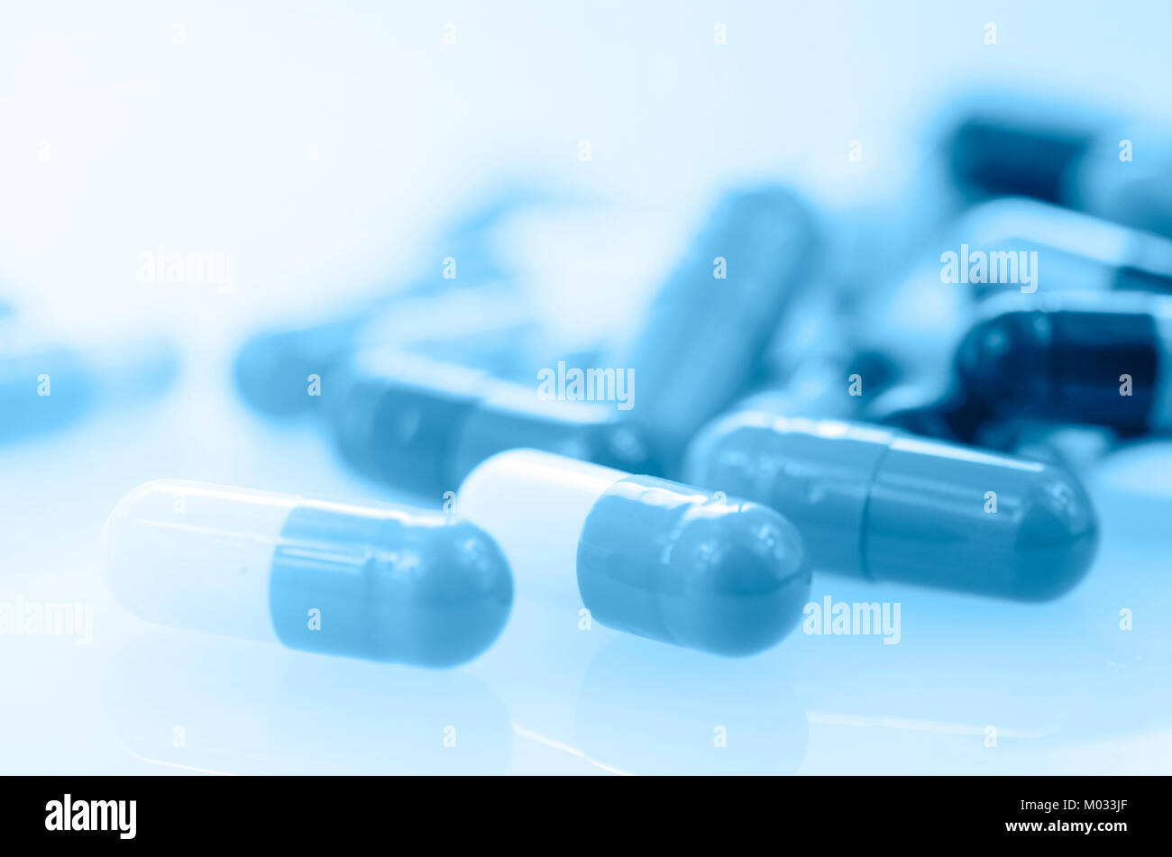 Oral medication background with warm light in blue tone. Stock Photo