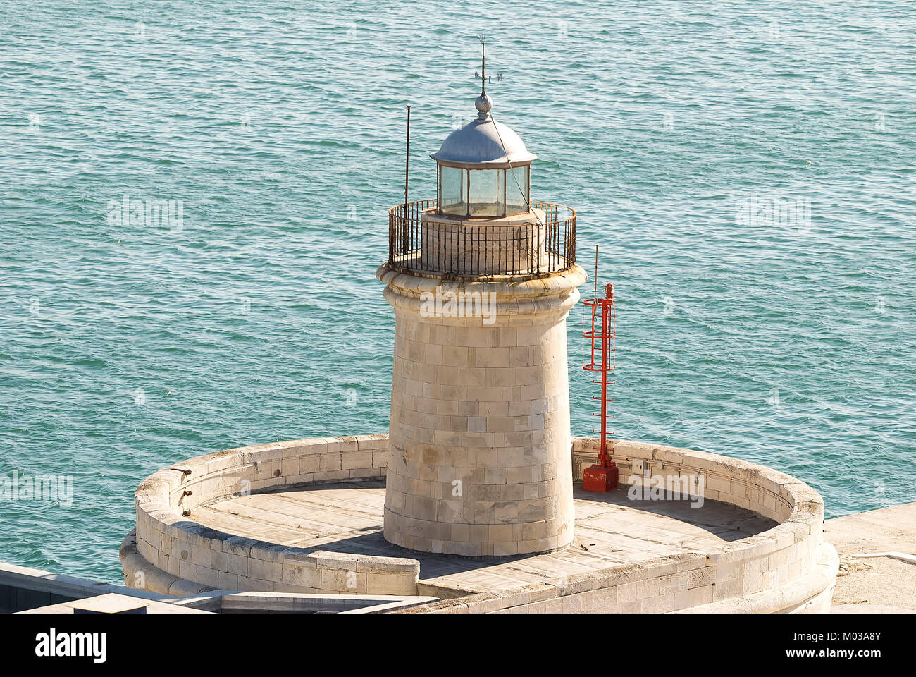 Small lighthouse with the sea Stock Photo