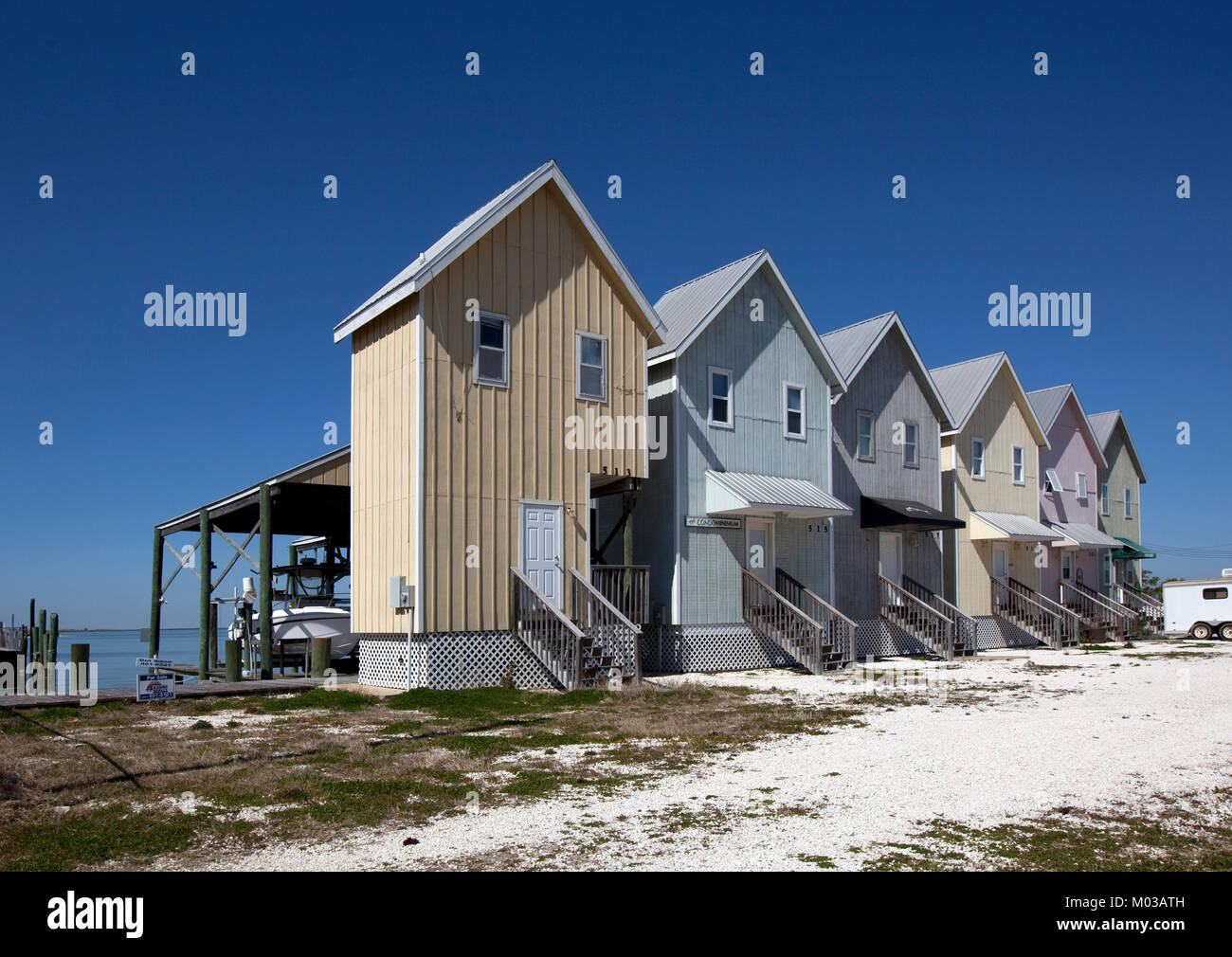 Fishing houses line the beach on Dauphin Island, Alabama Stock Photo