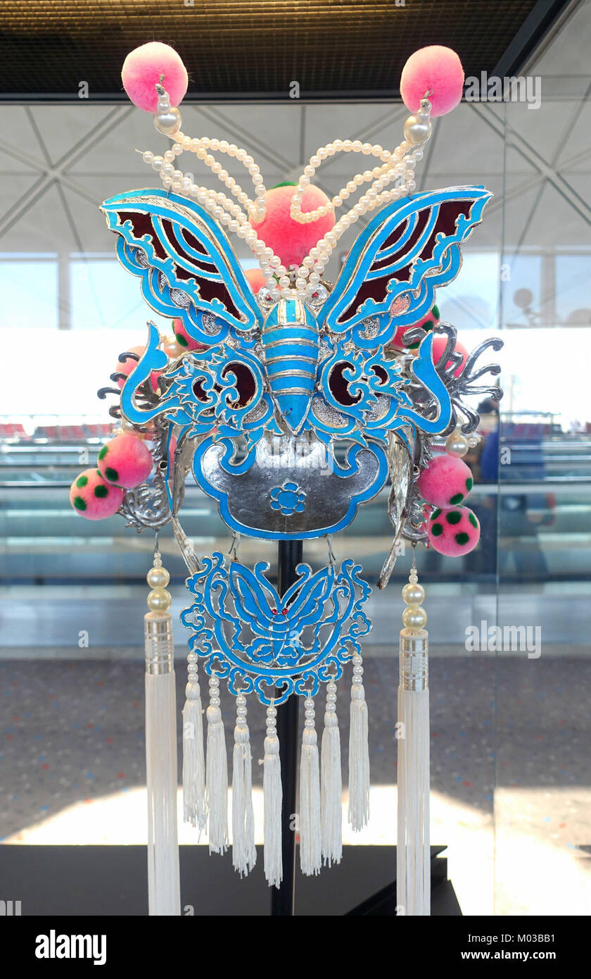 The photo shows the rear view of a butterfly headgear worn as part of a ...