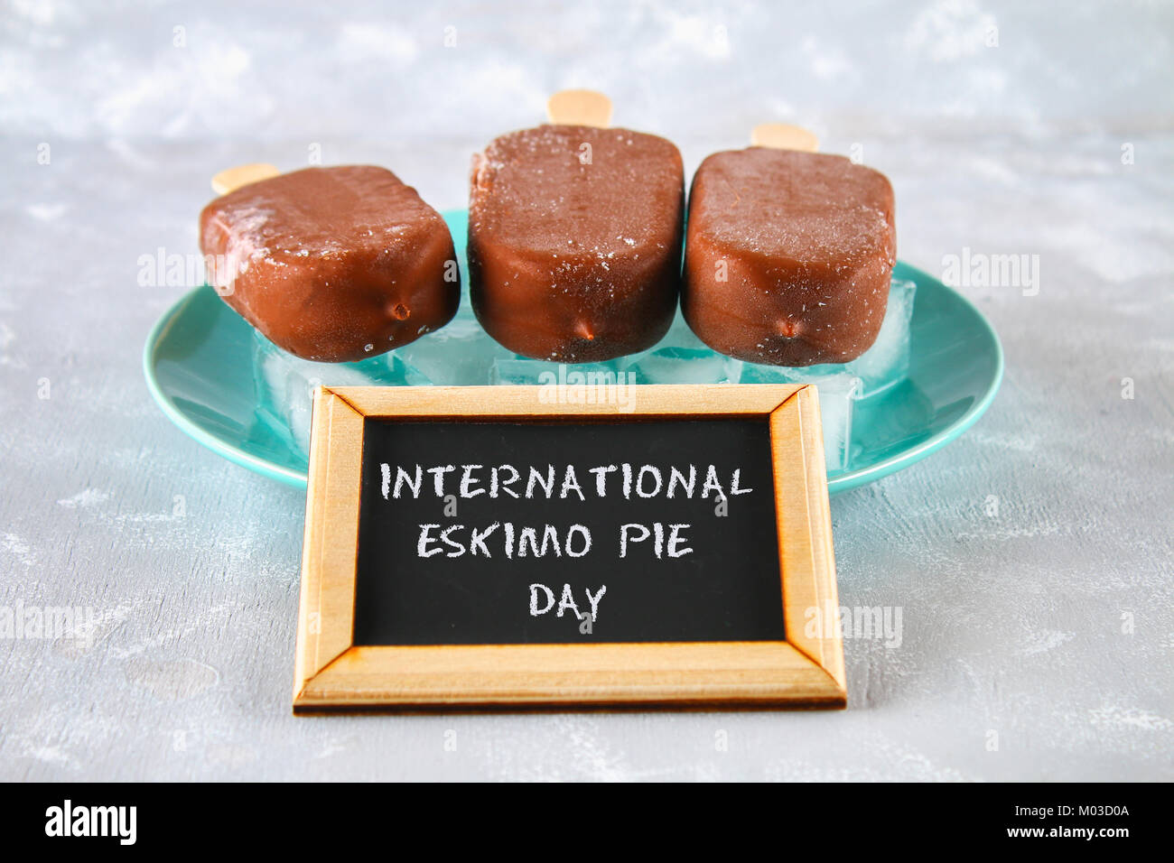 Ice cream eskimo pie on a stick with text on a gray background. Concept for the holiday