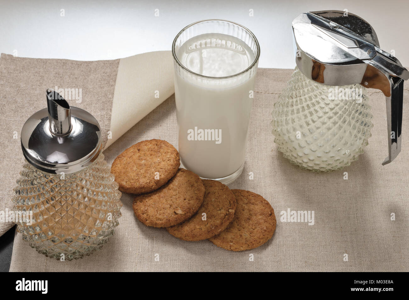 milk glass with biscuits with milk jug and sugar bowl from above Stock  Photo - Alamy