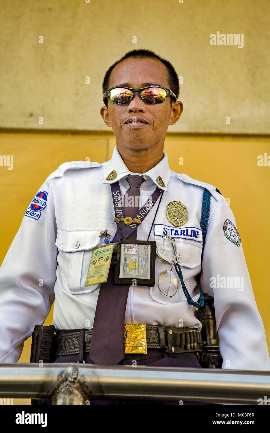 Starline is the major supplier of security guards throughout the Philippines. This mall cop stands guard in Legazpi City, Luzon, Philippines. Stock Photo