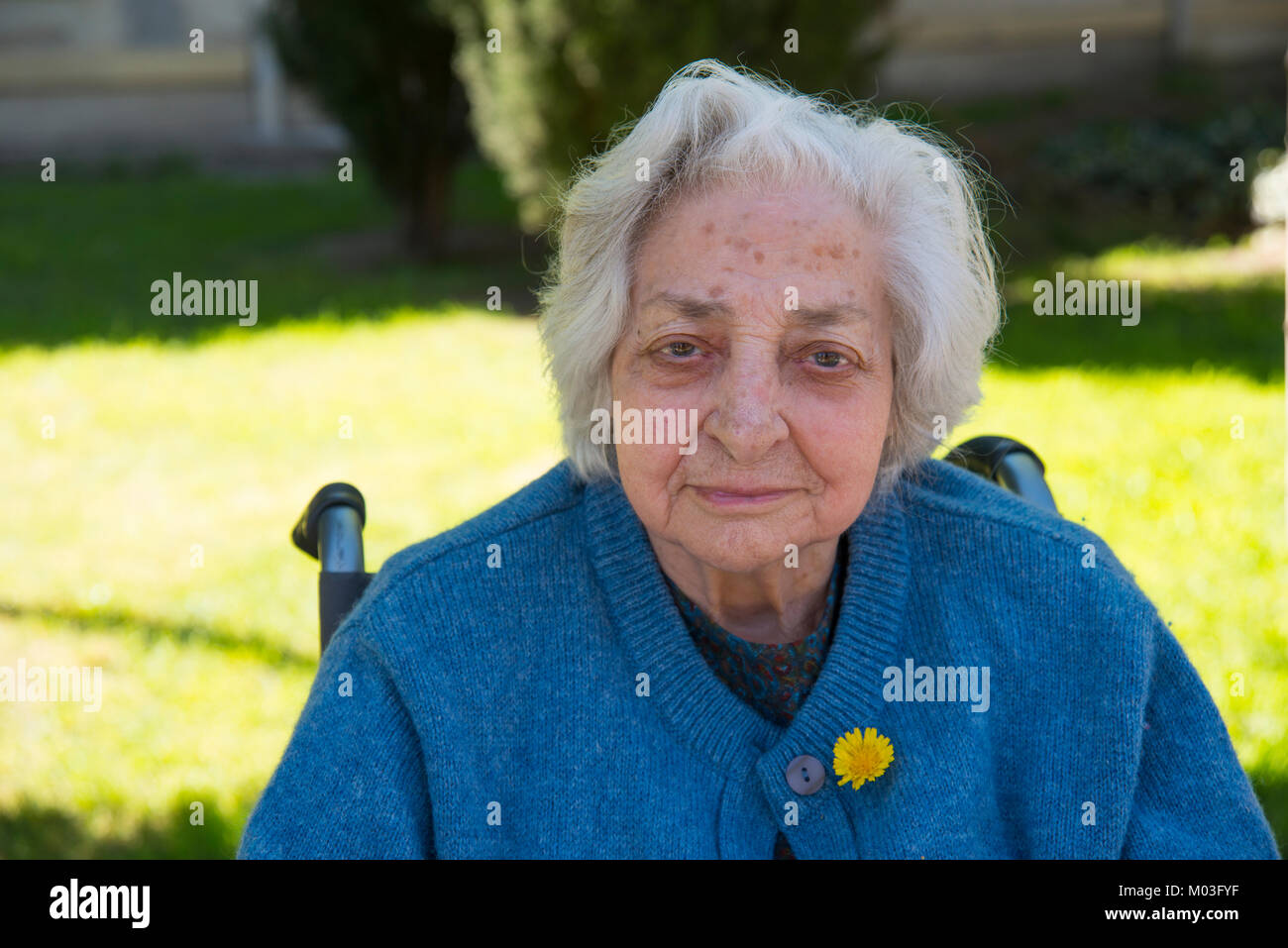 Portrait of old lady in the garden of a nursing home. Stock Photo