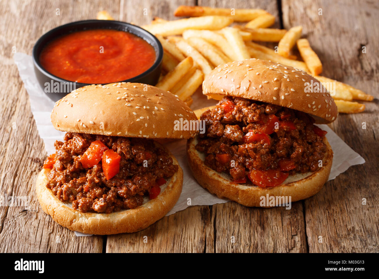 Homemade sandwiches with meat Sloppy Joe and french fries, ketchup closeup on the table. horizontal Stock Photo