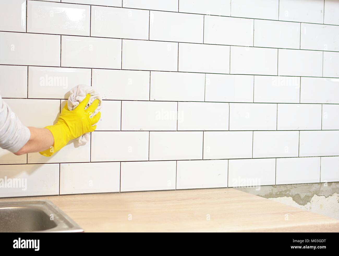 finishing the tiling of the kitchen with white tiles Stock Photo Alamy