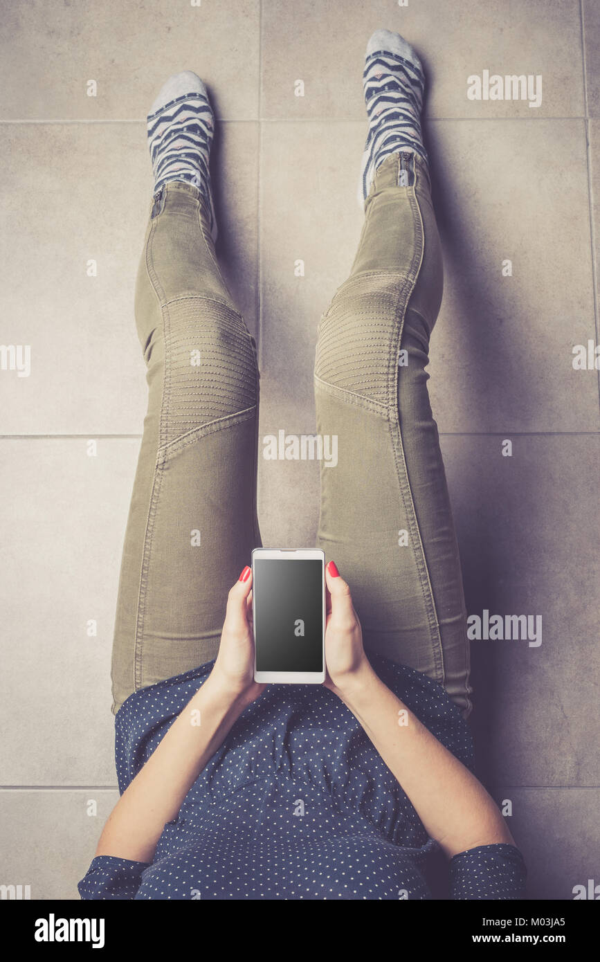 Using Phone Top View Young woman using modern smart phone. Top view Stock Photo - Alamy