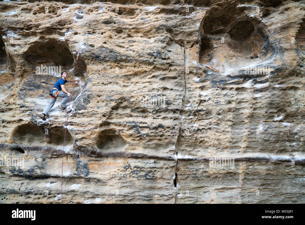 One man climbing into the Hueco in Red River Gorge, Kentucky. Stock Photo