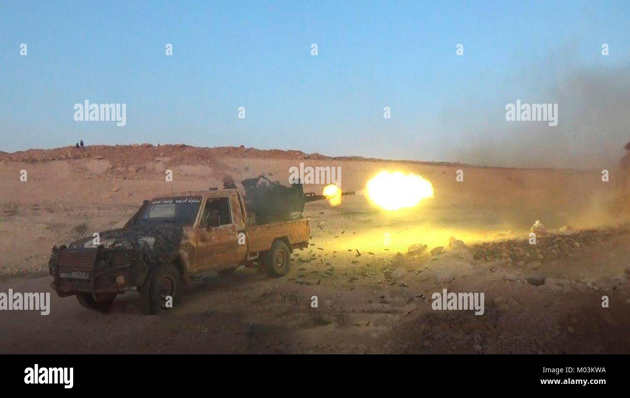 Still image taken from a propaganda video released January 13, 2018 showing Hay'at Tahrir Al-Sham Islamic State fighters firing artillery at Syrian Army positions near Abu Duhur Airbase in the Idlib Governorate, Syria. Stock Photo