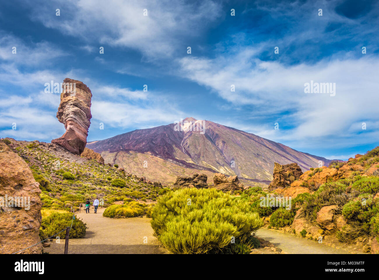 Roque Cinchado unique rock formation with famous Pico del Teide mountain volcano summit in the background on a sunny day, Tenerife, Canary Islands Stock Photo