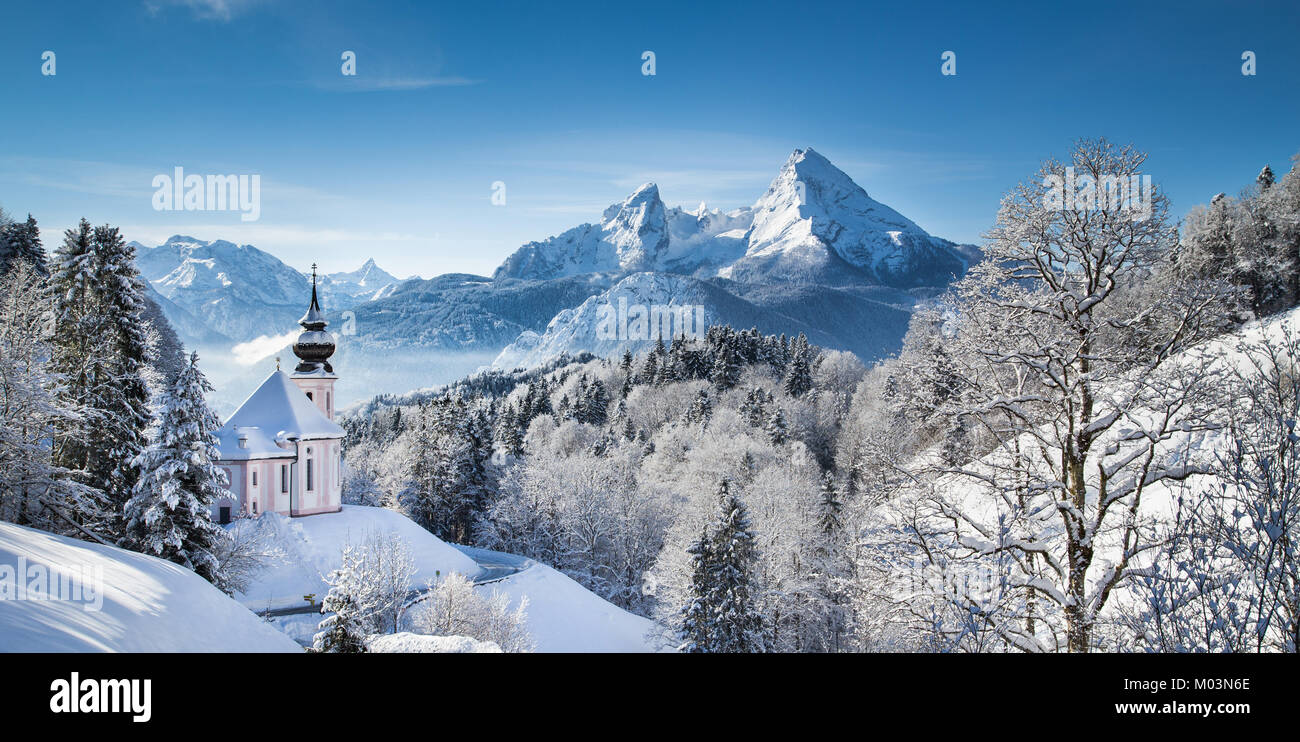 Panoramic view of beautiful winter landscape in the Bavarian Alps with pilgrimage church of Maria Gern and famous Watzmann massif in the background, N Stock Photo