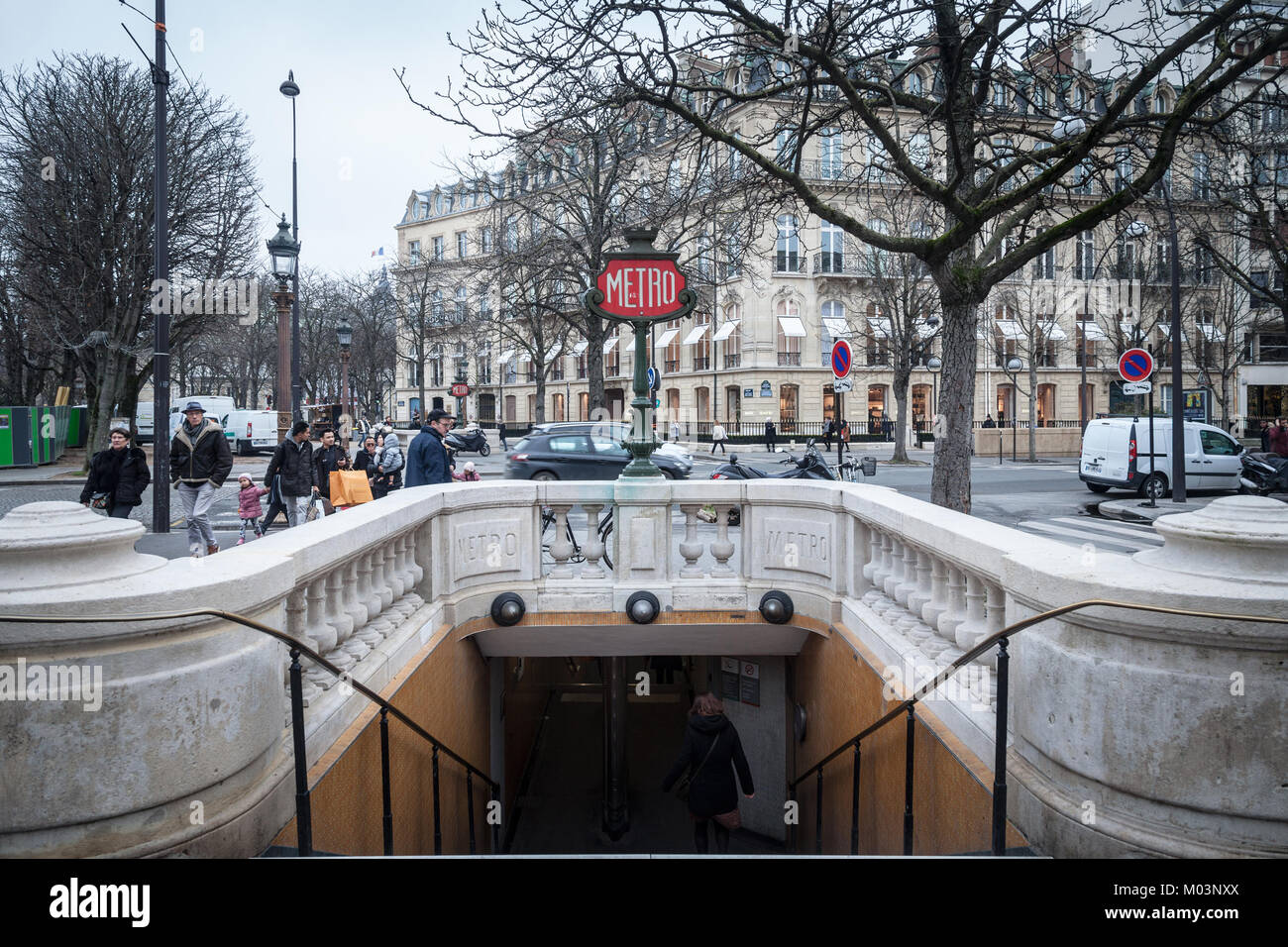 PARIS, FRANCE - DECEMBER 20, 2017: Paris Metro Station on Champs Elysees avenue with a typical old time Metro sign combined to a street lamp. Paris un Stock Photo