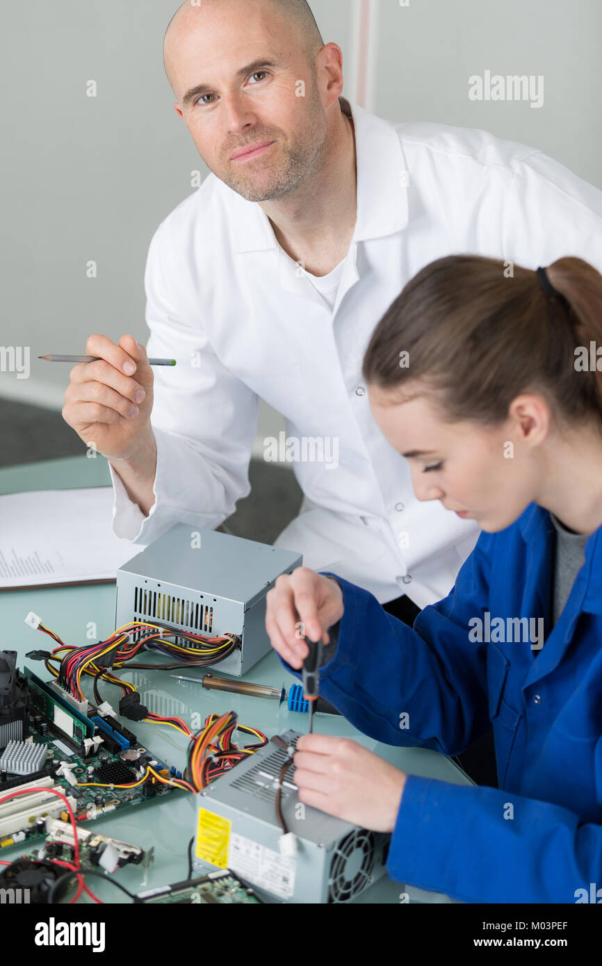 Fixing Computer Hard Way woman fixing a computer hard drive at business place Stock Photo - Alamy