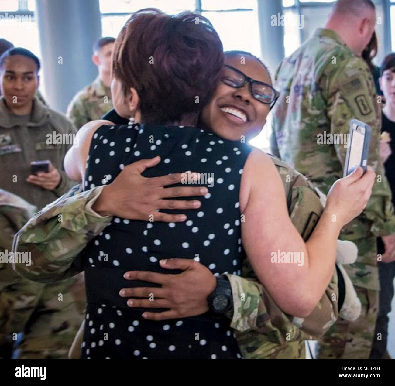 Capt. Melissa Coker embraces Megan Nunez during the redeployment ceremony for 254th Medical Detachment, Jan. 11 at Ramstein Air Base in Kaiserslautern, Germany. The combat operational stress control unit completed a 9-month deployment to Central Command area of responsibility. Stock Photo