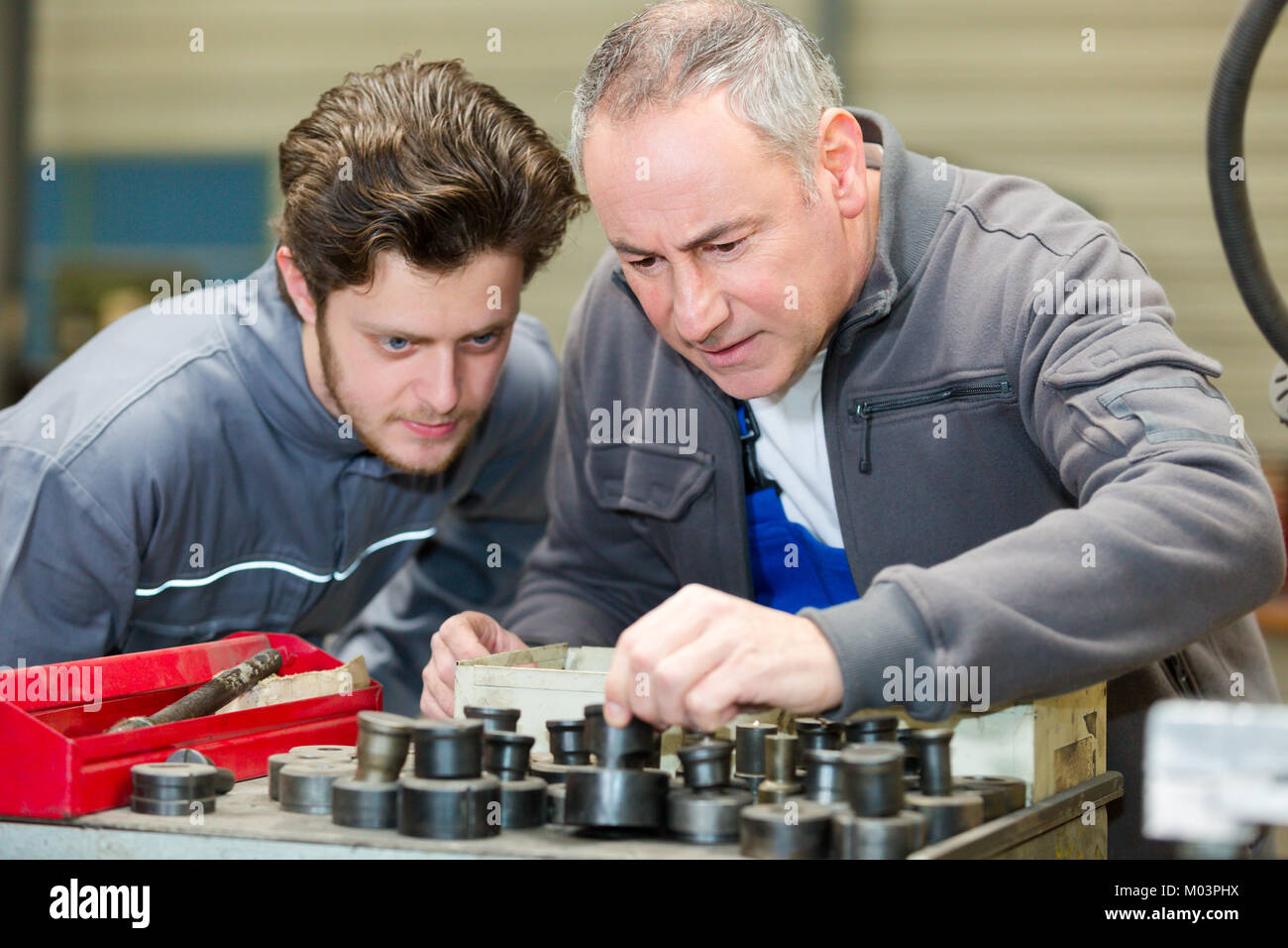 apprentice mechanic in auto shop working on car engine Stock Photo - Alamy