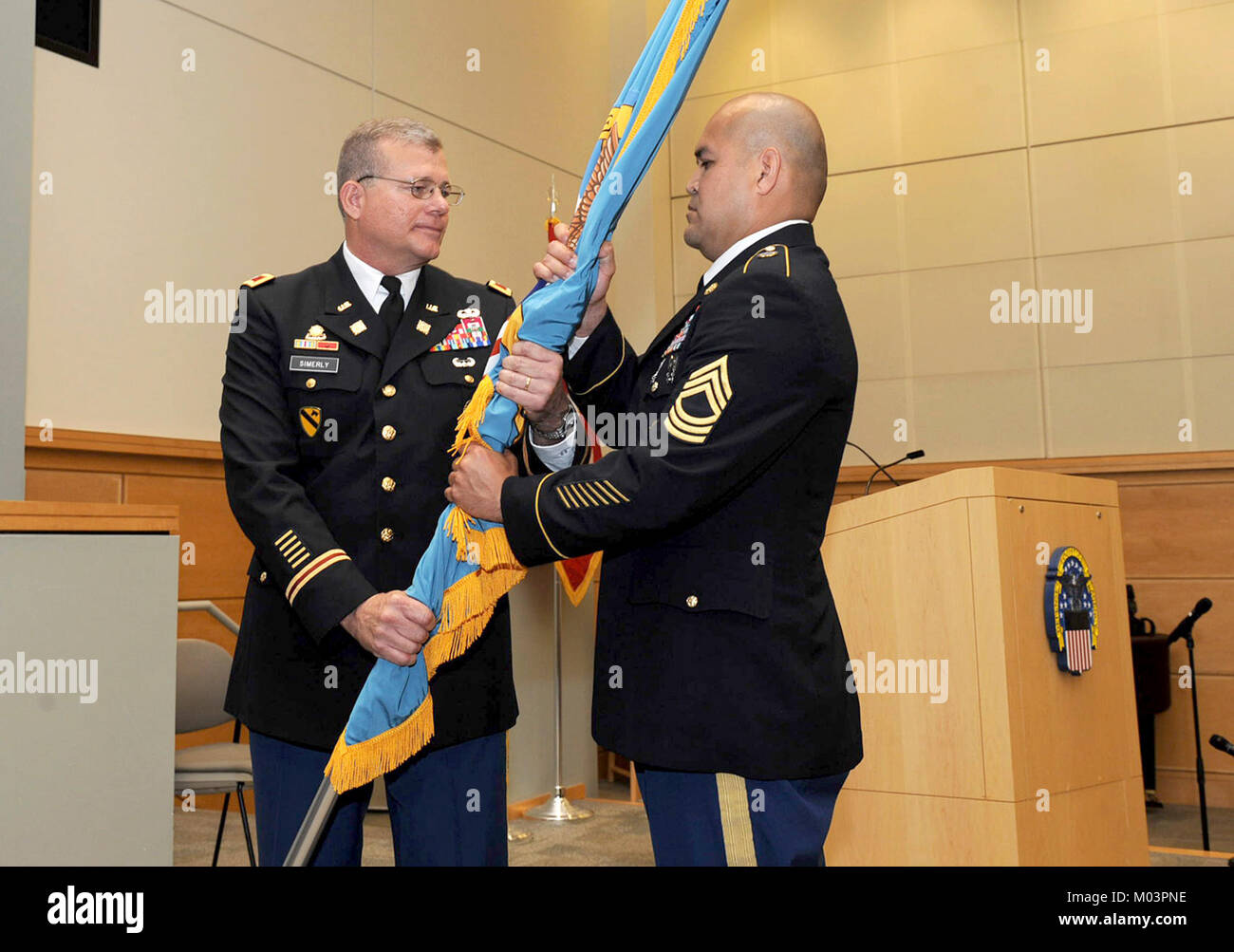 Army Col. Mark Simerly, DLA Troop Support incoming commander, passes the DLA flag to Army Master Sgt. Jose Moraga, DLA Troop Support senior enlisted service member, during a change of command ceremony July 11 in Philadelphia. Simerly was previously the director of capabilities, development and integration with the Combined Arms Support Command at Fort Lee, Virginia. Stock Photo