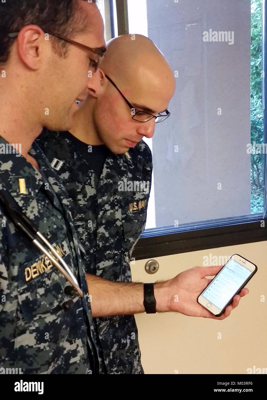 Navy Ensign Cole Denkensohn (left), a fourthyear medical student at