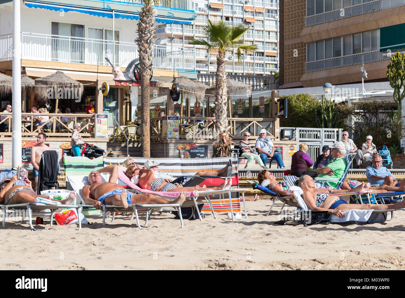 Levante Beach, Benidorm, Costa Blanca, Spain, 18 January 2018. British holidaymakers escape the cold weather in the UK. Tourists and locals enjoy the winter sun and daytime temperatures in the high 20's Celsius. Stock Photo