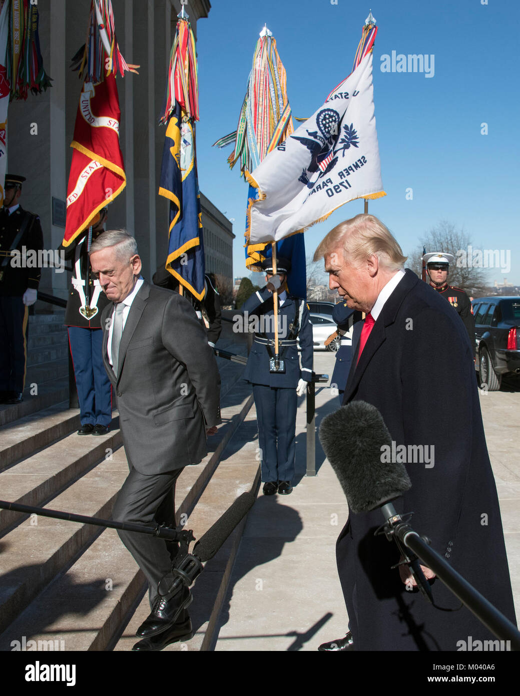 United States President Donald J. Trump, accompanied by US Secretary of Defense Jim Mattis, left, walks up the steps into the Pentagon after making a statement in Washington, DC on Thursday, January 18, 2018. Credit: Ron Sachs/Pool via CNP /MediaPunch Stock Photo