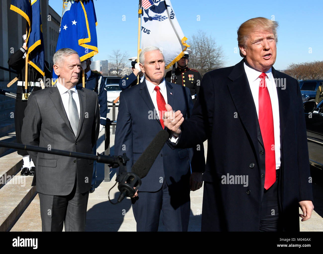 United States President Donald J. Trump makes a statement prior to going into the Pentagon in Washington, DC for meetings on Thursday, January 18, 2018. Looking on from left are US Secretary of Defense Jim Mattis and US Vice President Mike Pence. Credit: Ron Sachs/Pool via CNP /MediaPunch Stock Photo