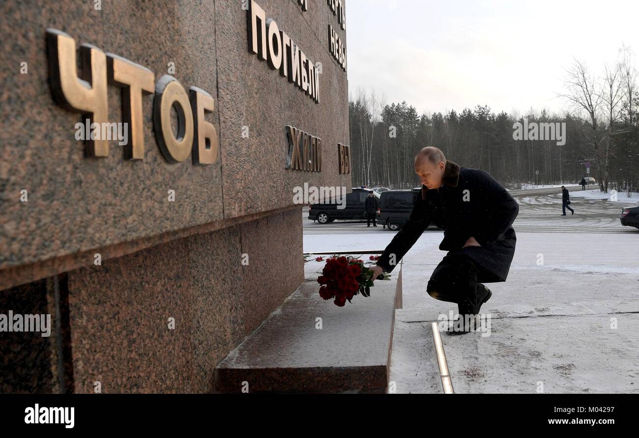 St Petersburg, Russia. 18th Jan, 2018. Russian President Vladimir Putin places red roses at a monument at Nevsky Pyatachok near Kirovsk during a ceremony January 18, 2018 in St. Petersburg, Russia. Putin attended events marking the 75th anniversary of the end of the Nazi's siege of Leningrad now called St. Petersburg. Credit: Planetpix/Alamy Live News Stock Photo