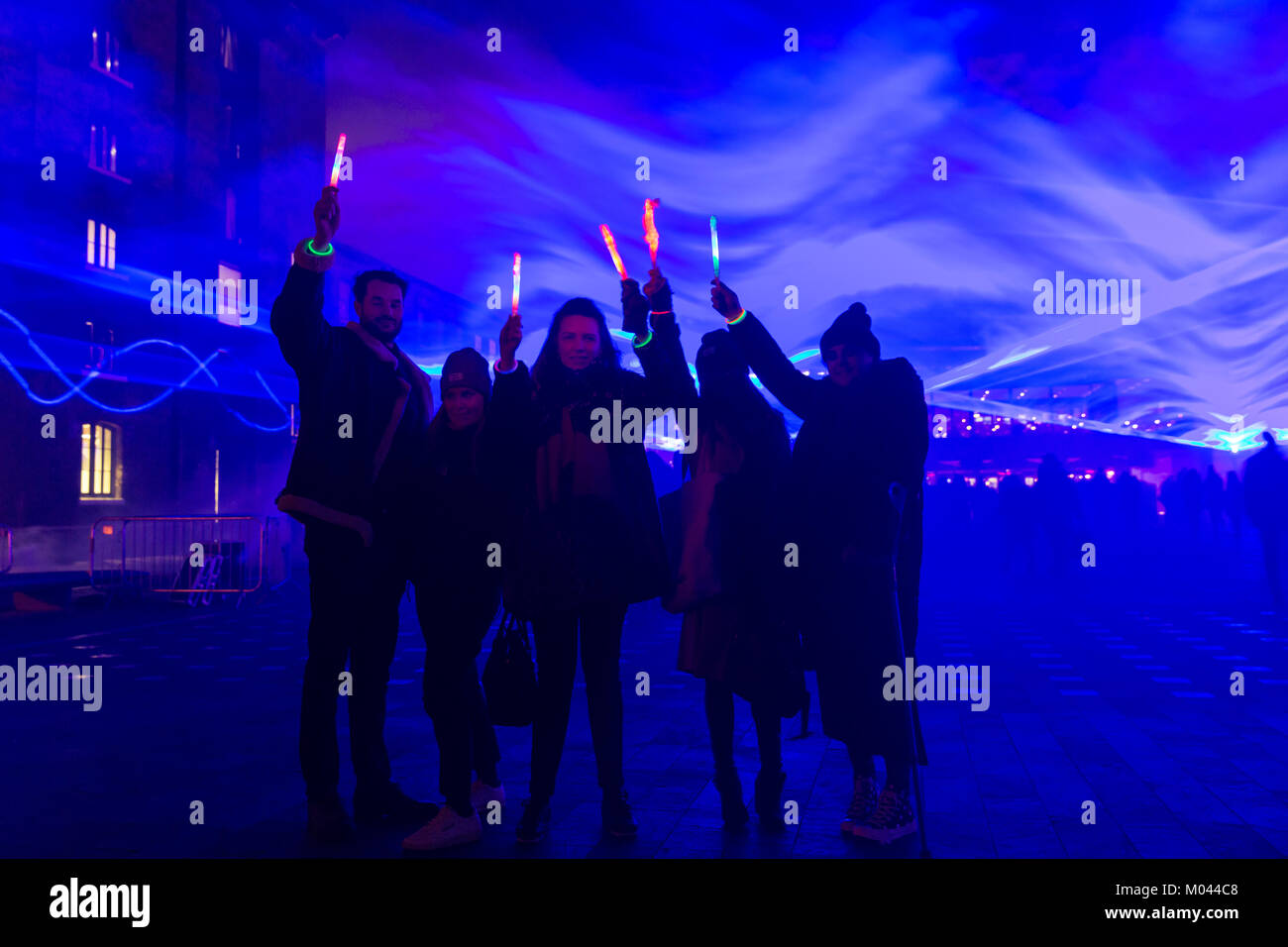 London, UK. 18th Jan 2018. People have fun and are mesmerised by the eerie blue light of the The Waterlicht installation by Daan Roosegaarde in Granary Square.Lumiere London 2018 Lights festival. Lumiere London is a light festival that presents an array of public art work and light installations across the capital. Credit: Imageplotter News and Sports/Alamy Live News Stock Photo