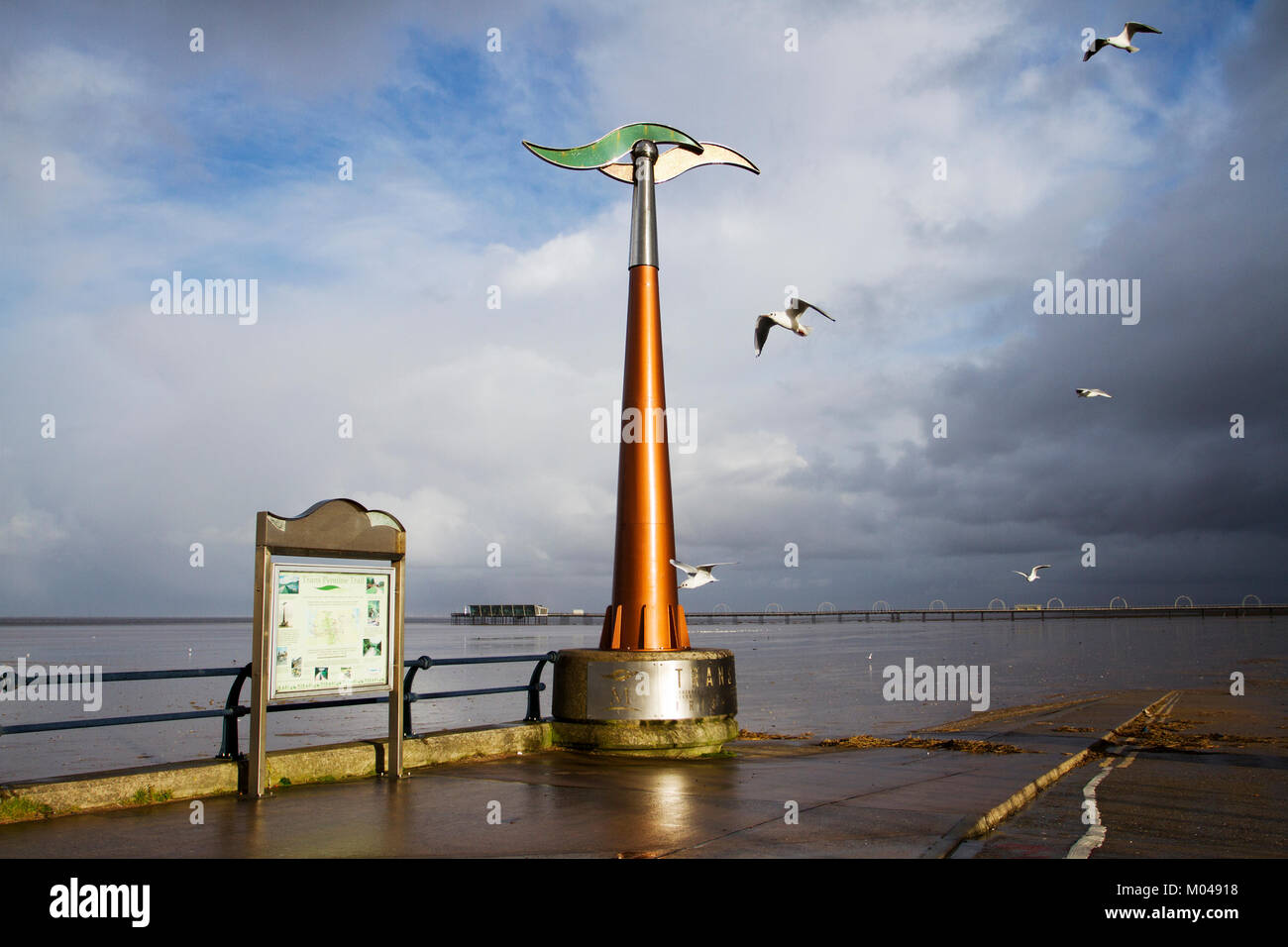 Southport,, Merseyside. 19th Jan, 2018. UK Weather. Sunshine and wintery showers on the coast with the spinning weathervane catching a rare burst of sunshine.  This monolith is a marker for the Trans Pennine way cycleway along the coastal paths of the resort promenade. Credit: MediaWorldImages/Alamy Live News Stock Photo