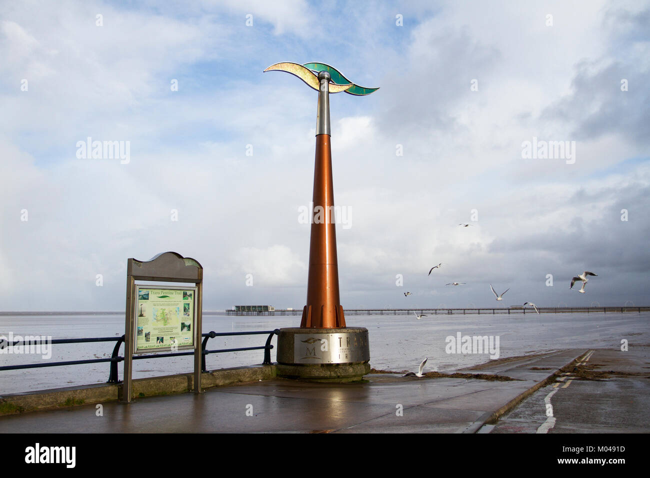 Southport,, Merseyside. 19th Jan, 2018. UK Weather. Sunshine and wintery showers on the coast with the spinning weathervane catching a rare burst of sunshine.  This monolith is a marker for the Trans Pennine way cycleway along the coastal paths of the resort promenade. Credit: MediaWorldImages/Alamy Live News Stock Photo