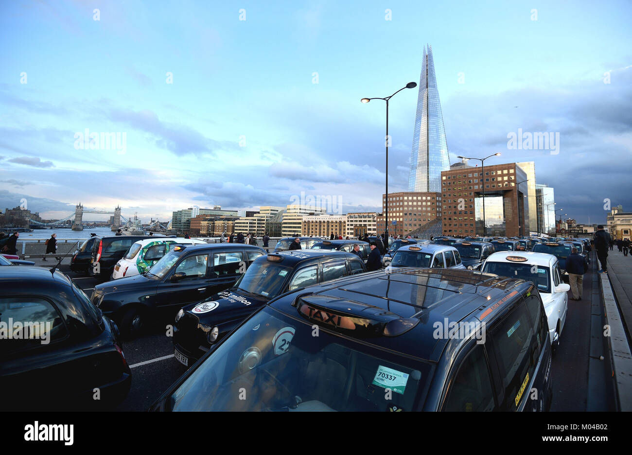 Black cab drivers take part in a protest against TfL and Uber, on London Bridge. Stock Photo