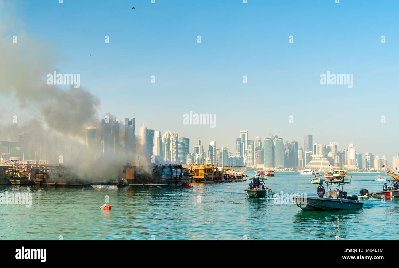 Traditional arabic dhow on fire in Doha, Qatar Stock Photo