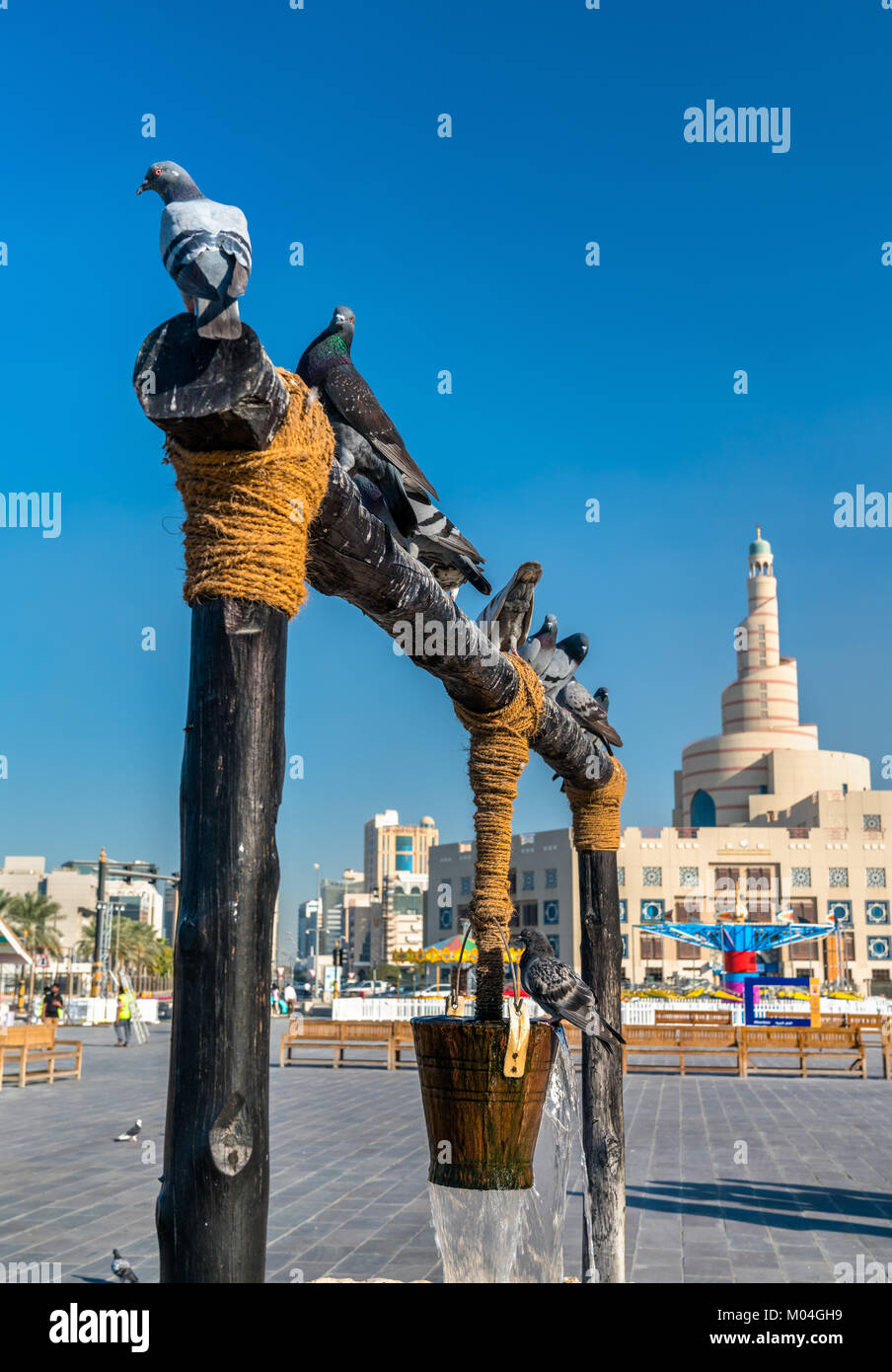 Old well with pigeons in front of the Souq Waqif in Doha, Qatar Stock Photo