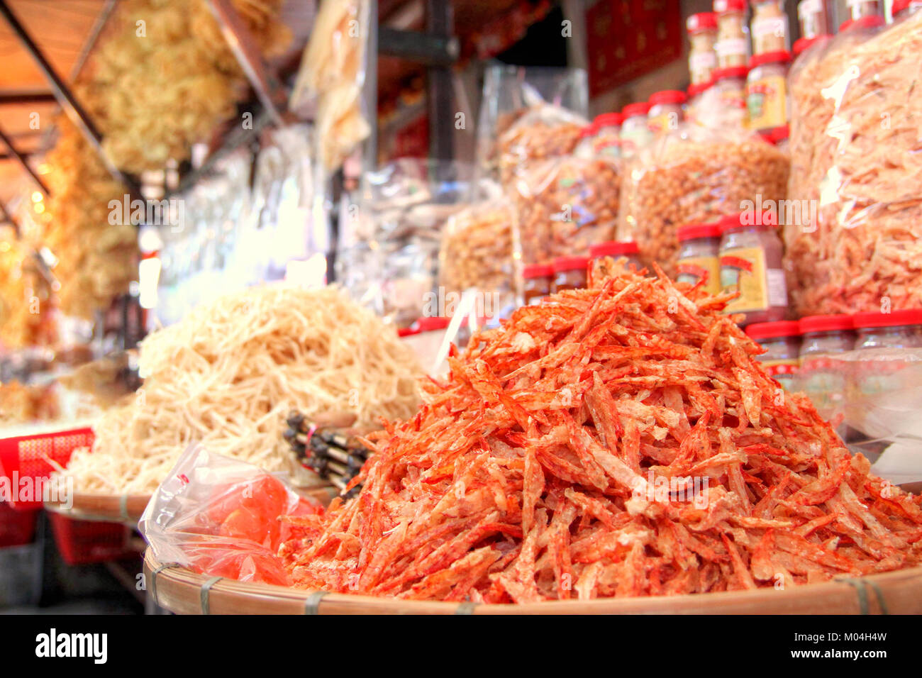 Focus on a pile of dried shrimp among other dehydrated seafood on sale at a store in Tai O, Hong Kong. Dried seafood delicacies are popular Chinese cu Stock Photo