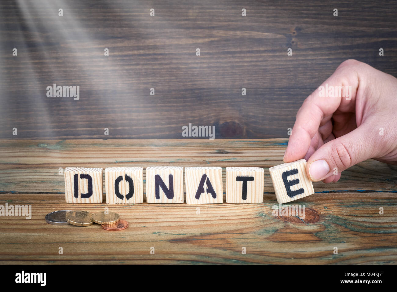 donate. Wooden letters on the office desk, informative and communication background Stock Photo