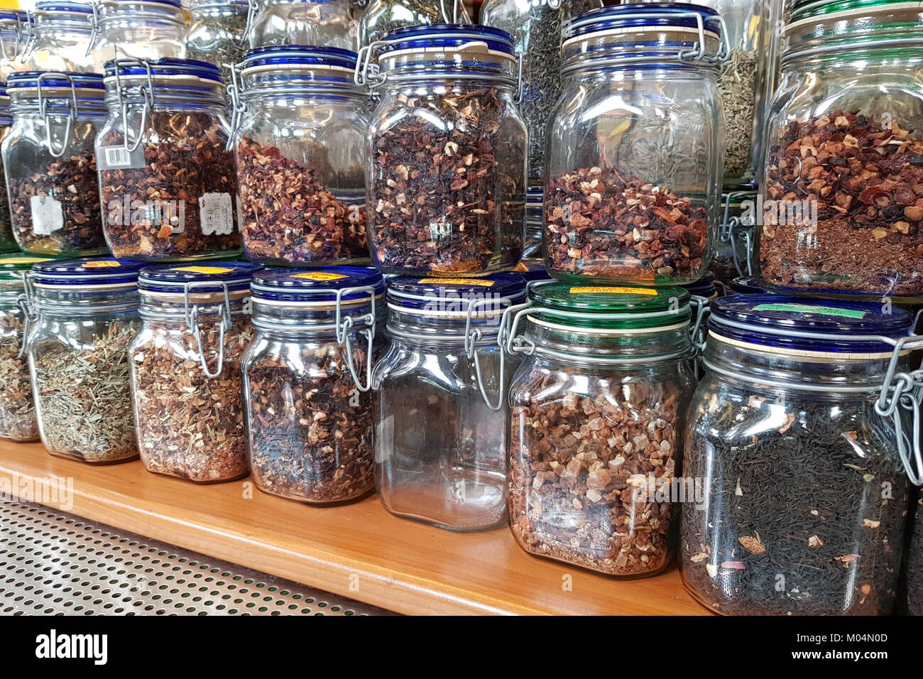 https://c8.alamy.com/comp/M04N0D/a-lot-of-dried-herbs-and-teas-in-jars-on-shelves-in-a-farm-market-M04N0D.jpg