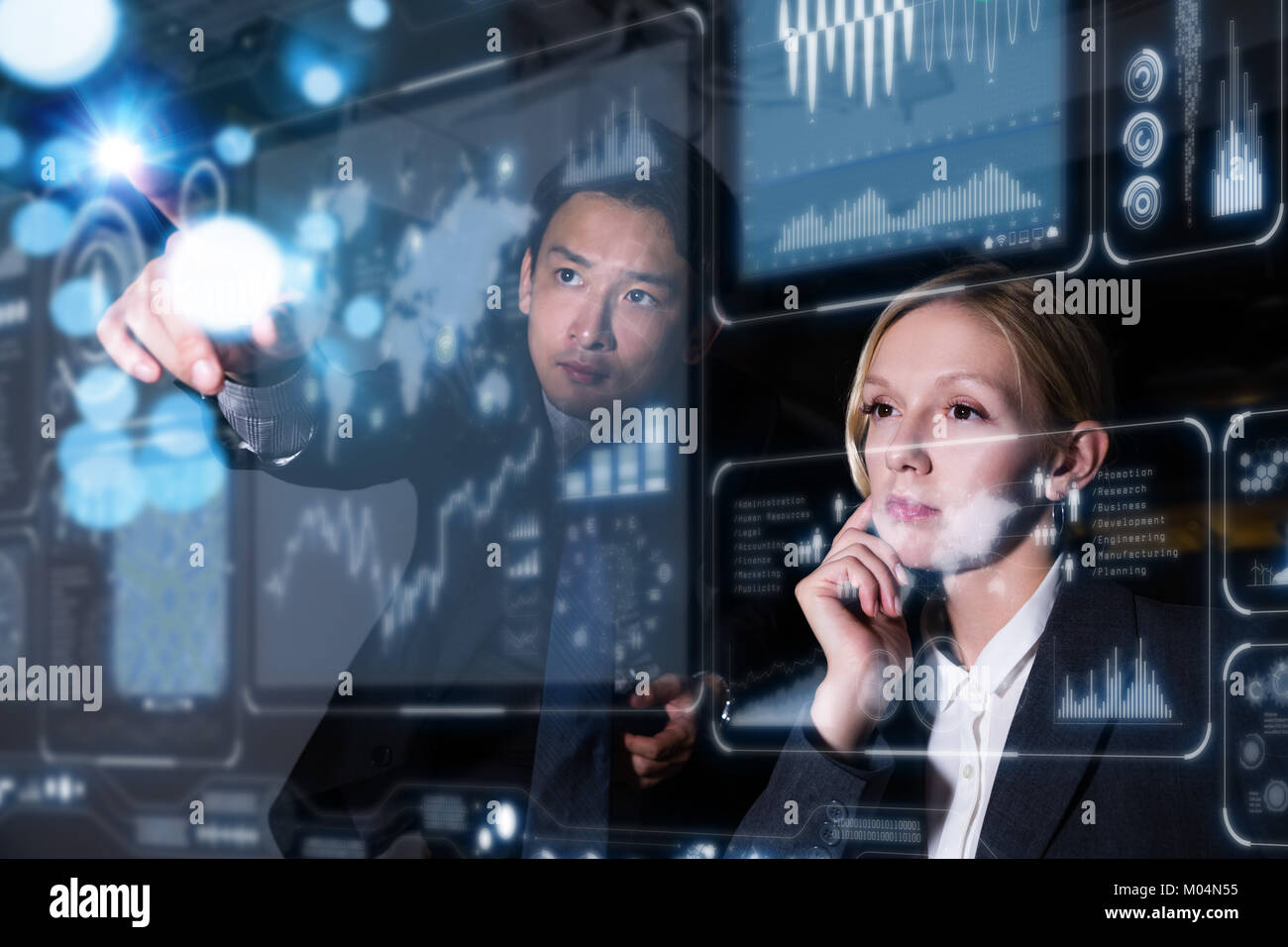 Two business persons in front of futuristic display. Social networking concept. Stock Photo