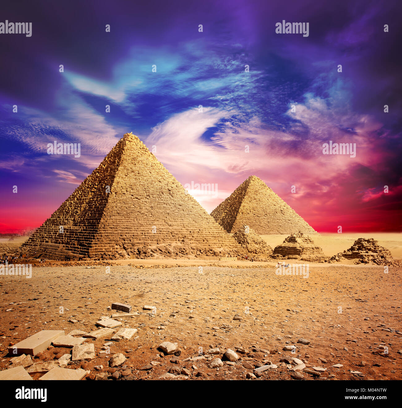 Pyramids in desert under ultra violet clouds Stock Photo - Alamy