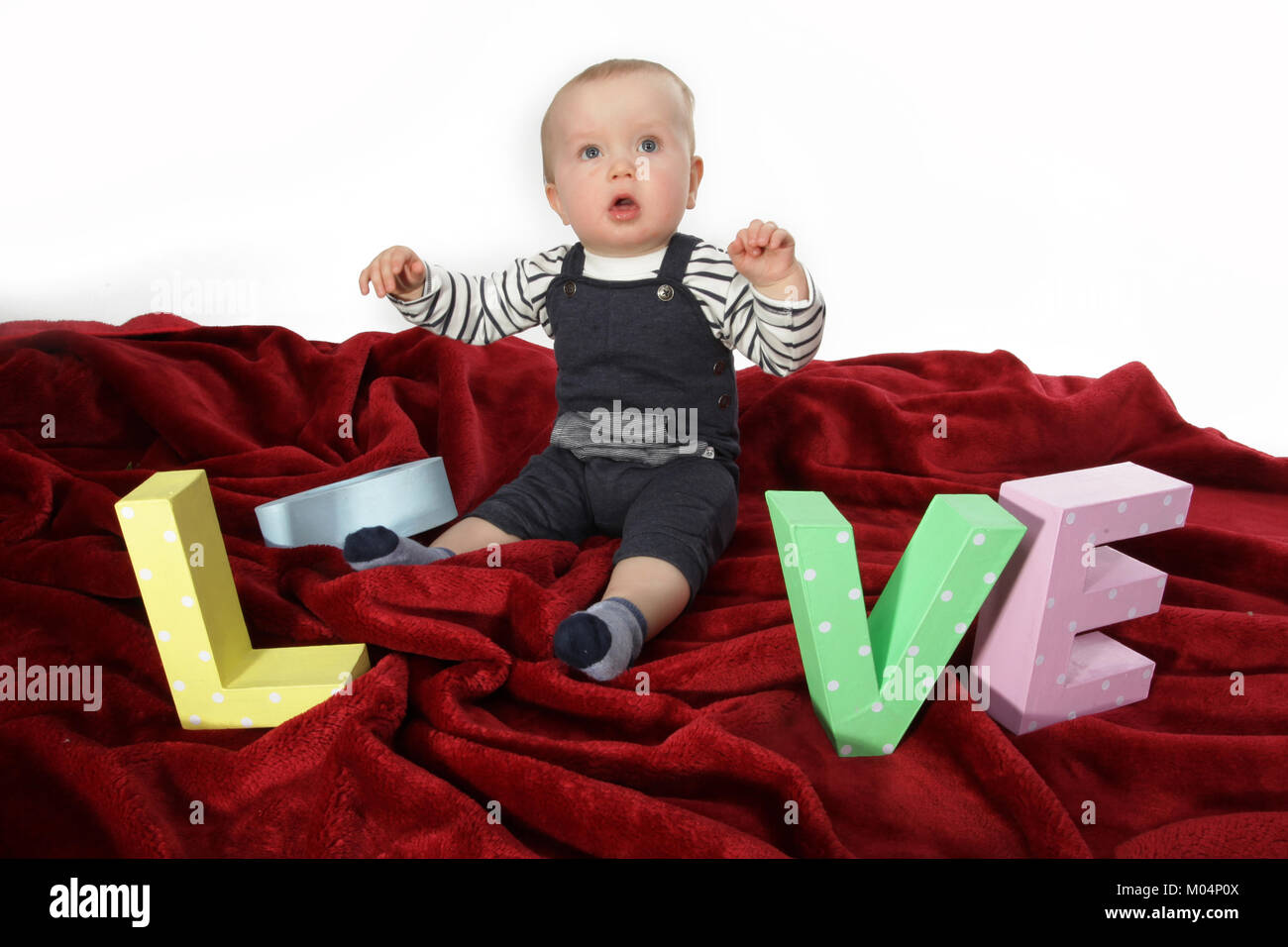 9 month old baby boy playing with big letters Stock Photo Alamy