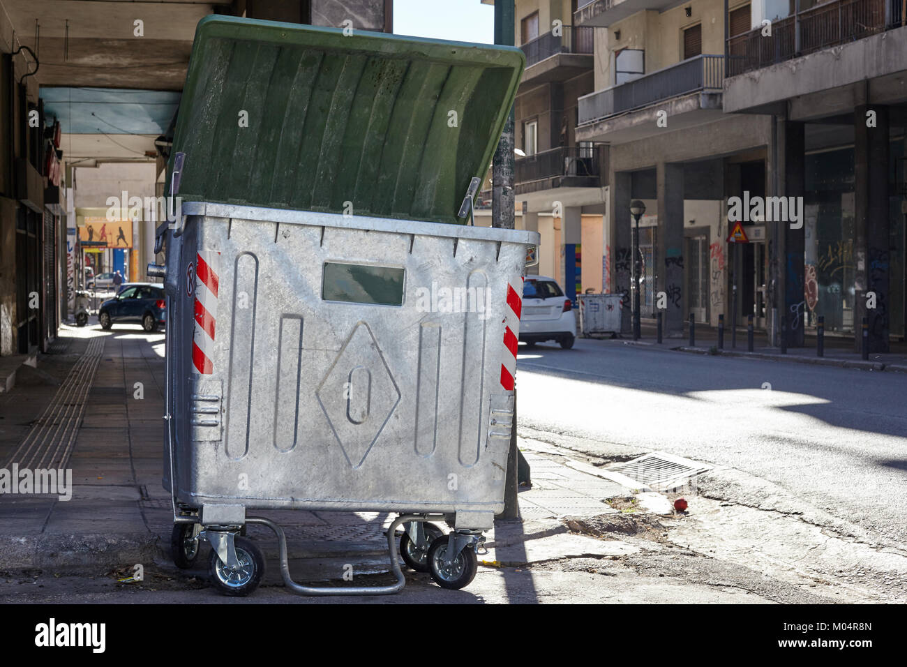 Grey dumpster on the road of a city Stock Photo Alamy
