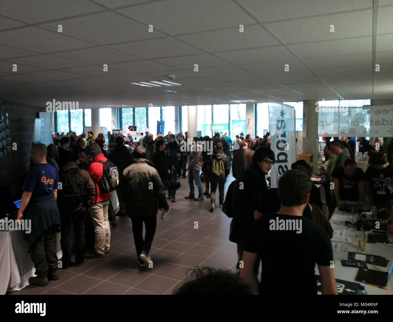 The photograph from FOSDEM 2015 in Brussels captures an event focused on open-source software development. FOSDEM is one of the largest gatherings of free software enthusiasts, developers, and advocates, promoting collaboration and knowledge exchange within the open-source community. Stock Photo