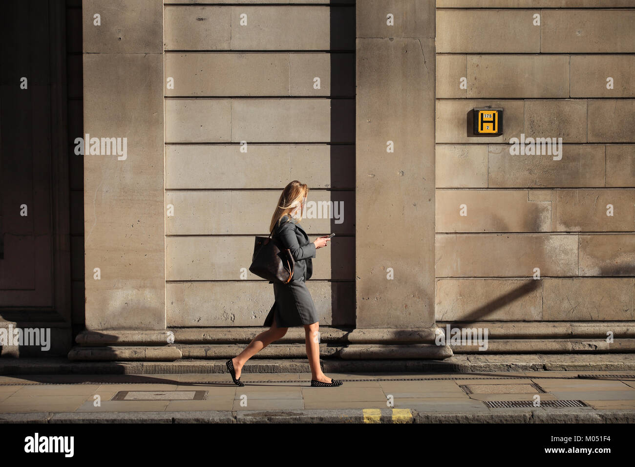 Businesswoman walking in City of London, England, Britain Stock Photo ...